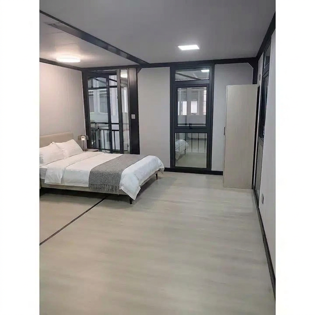 Upper floor bedroom with queen bed, bedside lamp and wardrobe beside the balcony glazing