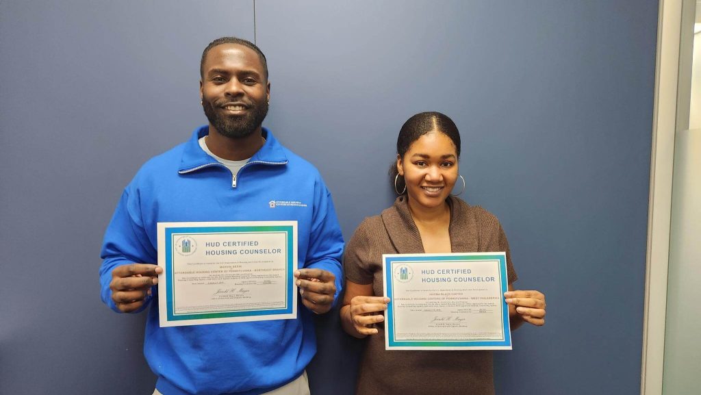 Two HUD Certified Housing Counselors displaying their HUD certification certificates
