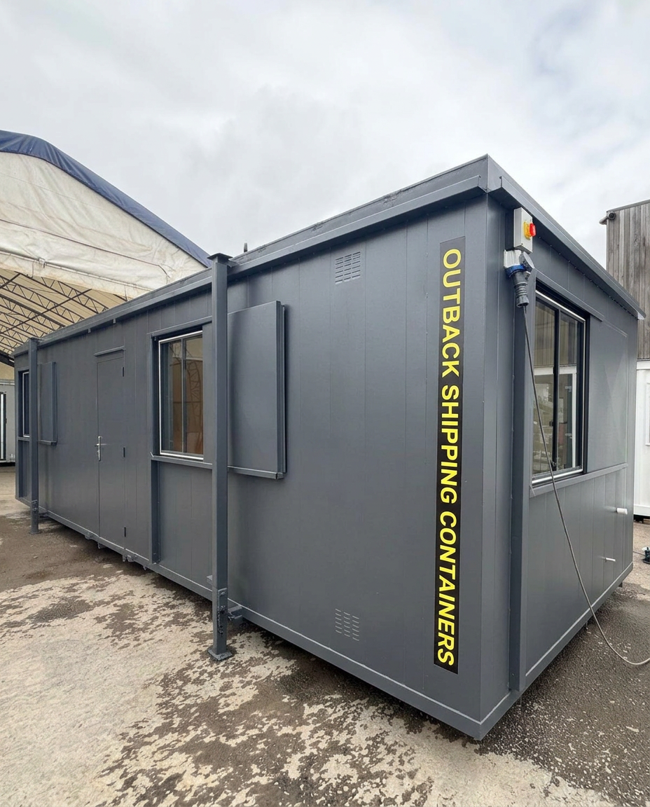 Interior of a refurbished 32x10 canteen office cabin with white walls and gray herringbone flooring