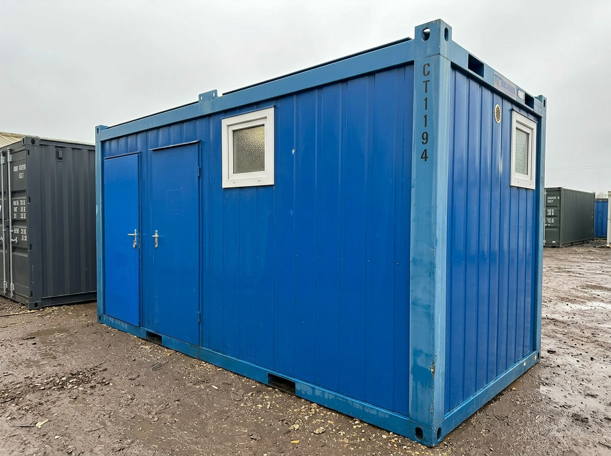 Opposite three-quarter corner view of the 16 x 8 ft portable toilet block cabin on a hardstanding yard