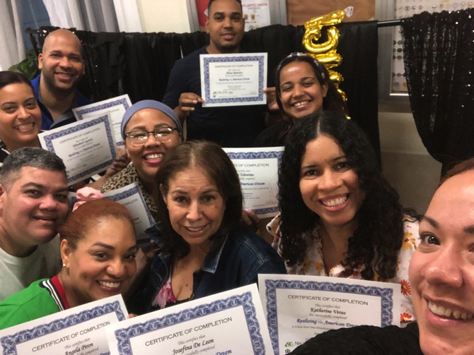 Homebuyer education class graduates holding certificates of completion
