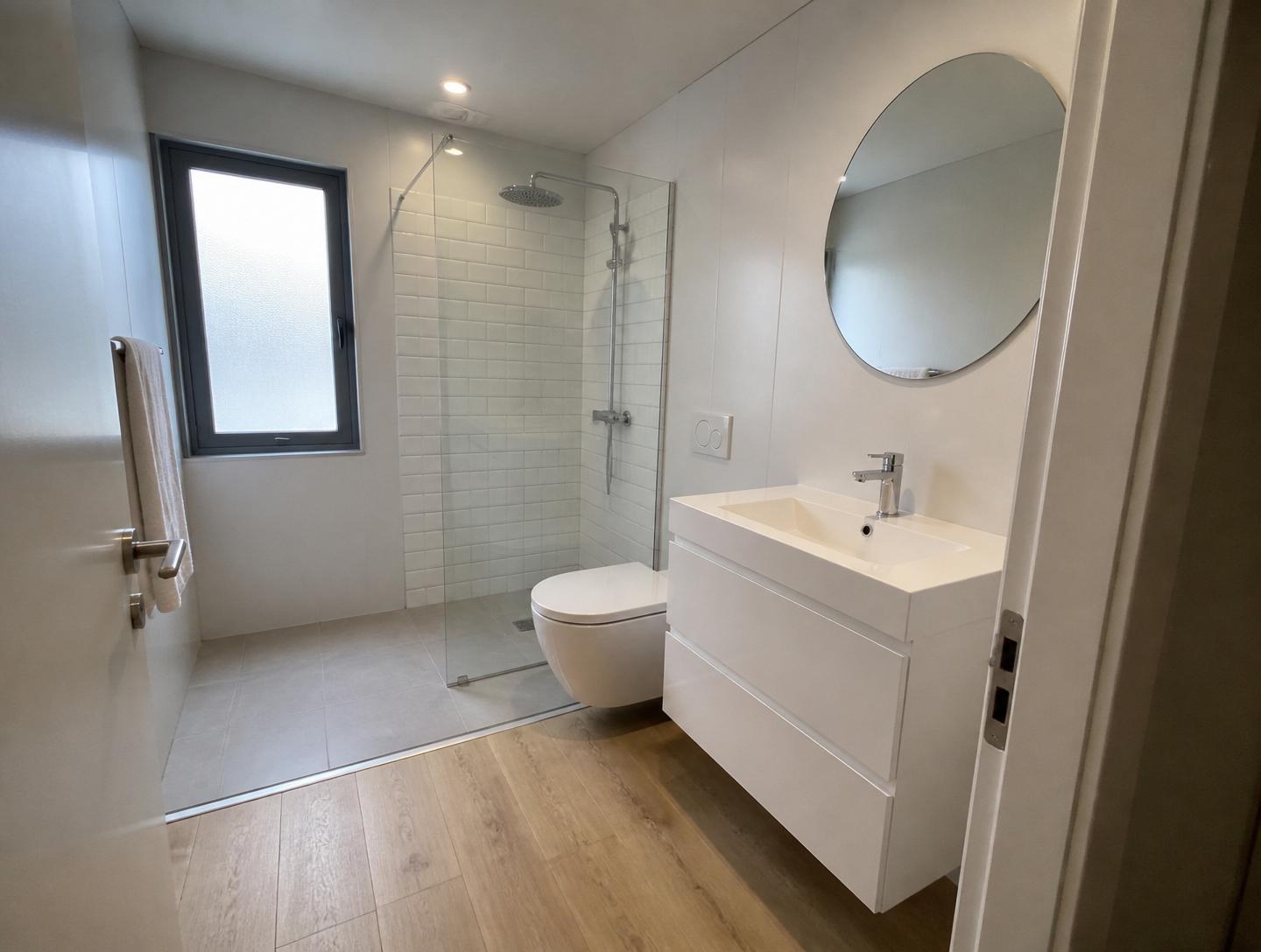 Luxury 40ft prefab container house interior — full bathroom with walk-in glass shower, floating white vanity and round mirror